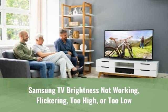 Grandfather, dad and son sitting on sofa watching TV